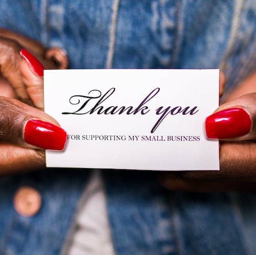person holding a thank you card